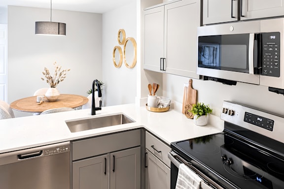 A modern kitchen with a black stove top oven.