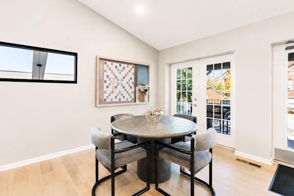 A dining room with a round table and chairs.