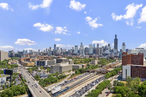 an aerial view of the cityscape with highways and skyscrapers