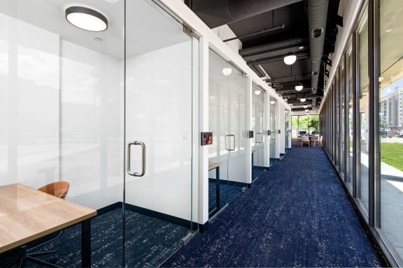 a row of glass doors in a room with tables and chairs