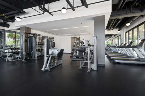 a workout room with weights and cardio equipment in a gym