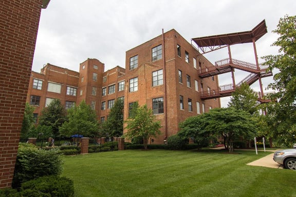 a large brick building with a lawn in front of it