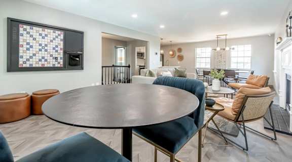 A modern living room with a round table and chairs.