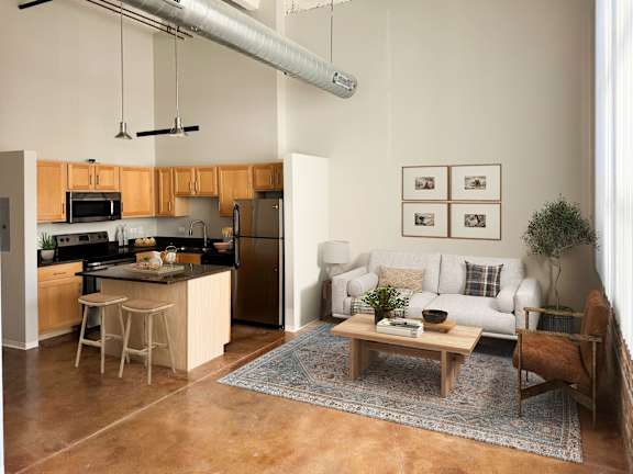A kitchen with a refrigerator, microwave, and oven.