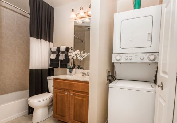 bathroom with a stacked washer and dryer