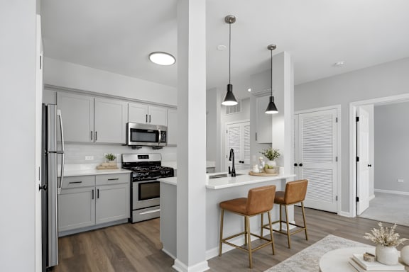 A modern kitchen with white cabinets and a wooden island.