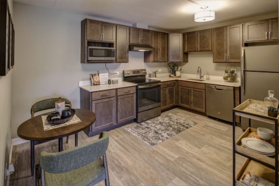 apartment kitchen with wooden cabinets and stainless steel appliances