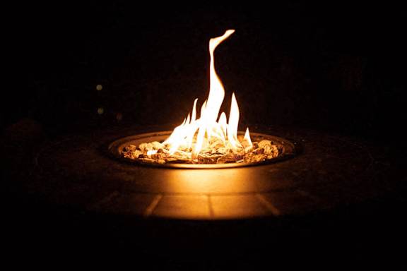A fire burns brightly in a fire pit.