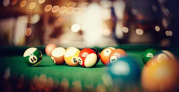 A pool table with balls numbered 14, 6, 5, 4, 3, 2, and 1 visible.