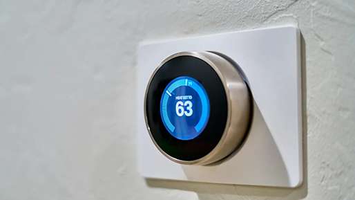 A thermostat shows the temperature as 63 degrees.