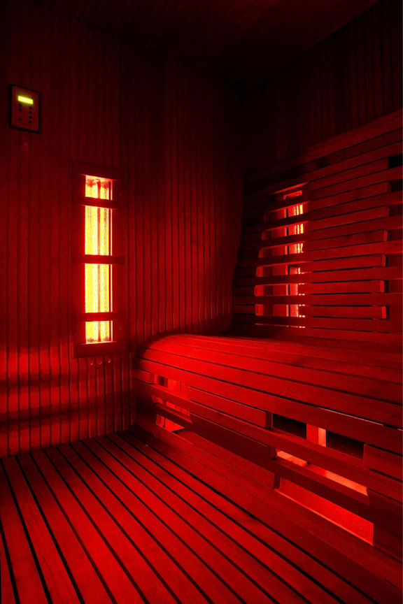 A room with wooden benches and red lighting.