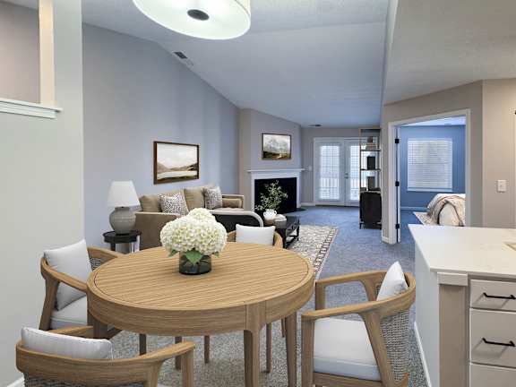 A living room with a wooden table and chairs.
