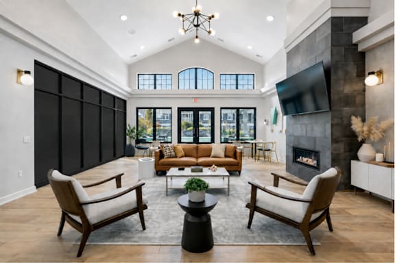 A modern living room with a fireplace and a large window.