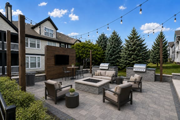 A patio with a fireplace and seating area.