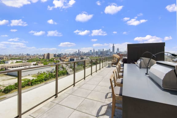 a rooftop terrace with a view of the city
