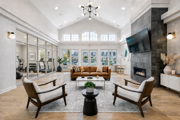 A modern living room with a fireplace and a television.