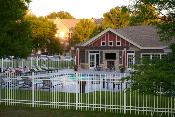 white fence enclosing the Valley Creek Apartments pool and clubhouse