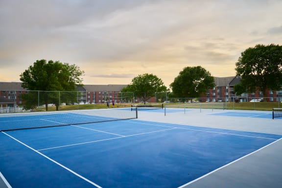 a blue tennis court behind Valley Creek Apartments in Woodbury, MN
