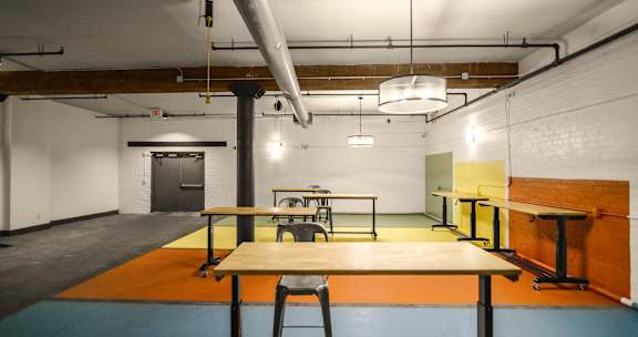 A room with a table and chairs in the center.