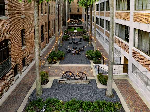 A courtyard with a fountain in the middle of it.