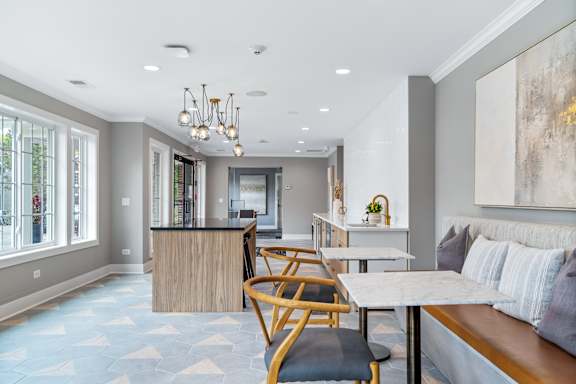 A modern living room with a dining area and kitchen in the background.