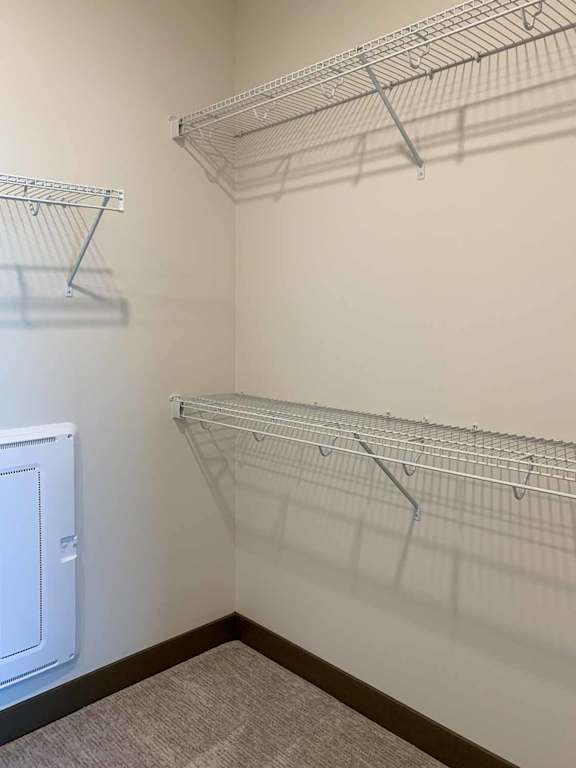 a walk-in closet with built-in shelves