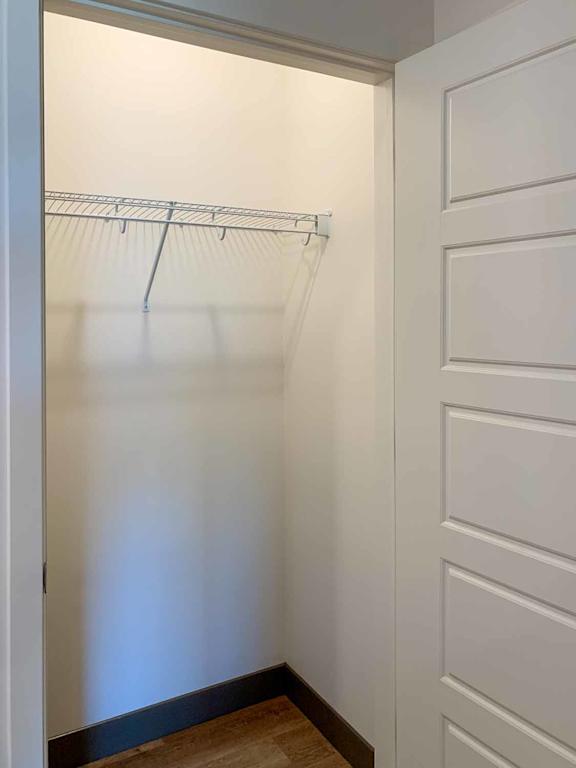 a coat closet with a built-in shelf