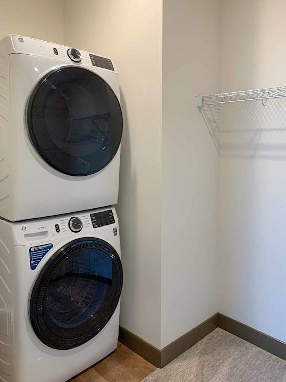 a stackable washer and dryer in the walk-in closet