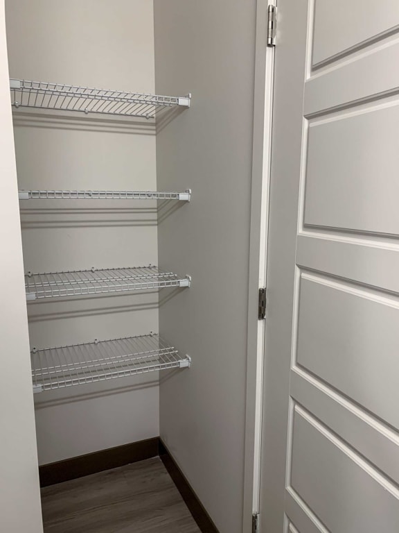 a pantry closet with several shelves