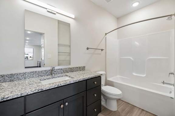 Convenient stacked washer and dryer tucked into a hallway closet beside the bathroom.