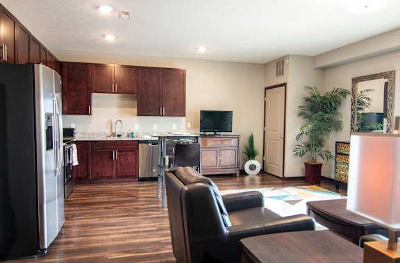 Open layout with living room and kitchen with stainless steel appliances at 360 at Jordan West best new apartments West Des Moines IA 50266