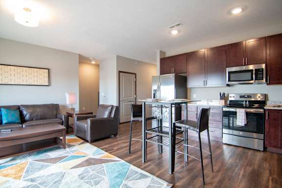 Open layout with dining and living room in a one bedroom with denat 360 at Jordan West best new apartments West Des Moines IA 50266