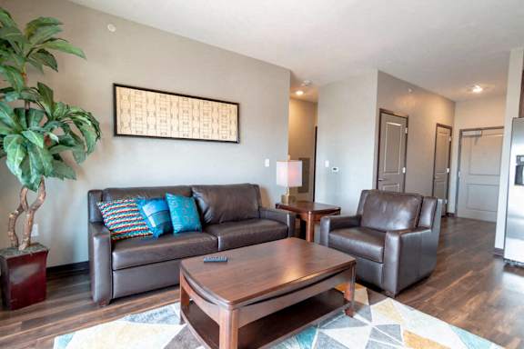 a living room with leather furniture and a coffee table