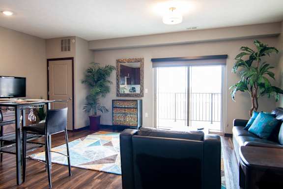 Living room with large glass doors providing lots of natural light at 360 at Jordan West