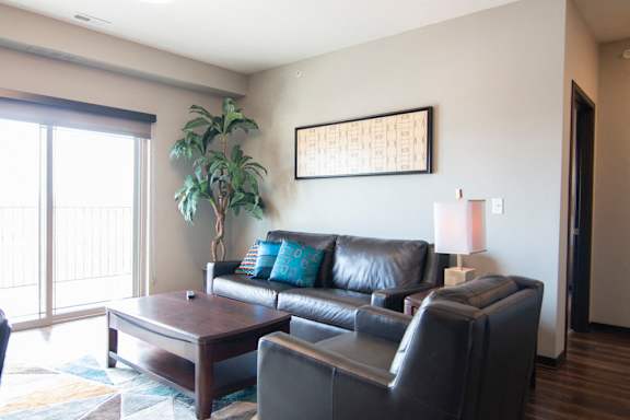 Couch and chair in a living room at 360 at Jordan West