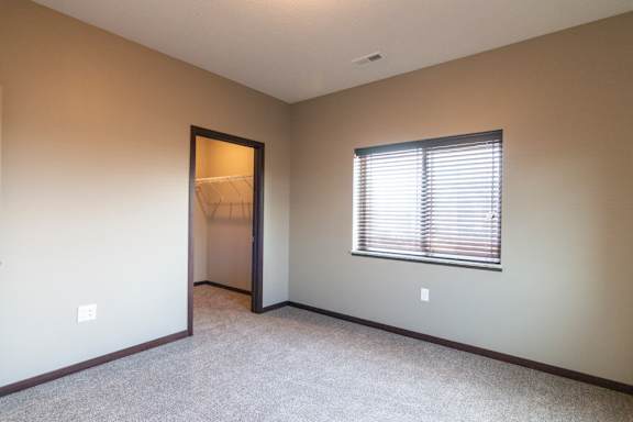 Bedroom with attached walk in closet at 360 at Jordan West