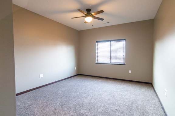 Bedroom with ceiling fan and window providing natural light at 360 at Jordan West