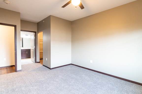 Bedroom with attached bathroom and ceiling fan at 360 at Jordan West