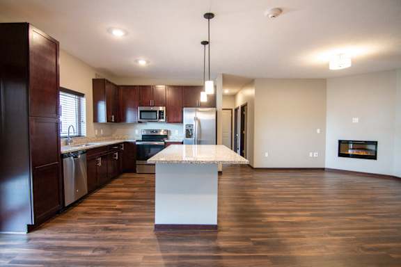 Kitchen and living room with hardwood-style flooring at 360 at Jordan West