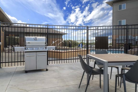 Poolside grills and picnic tables making for a perfect summer evening at 360 at Jordan West