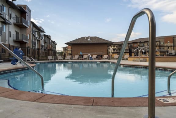 luxury resort style swimming pool with sun tanning lounge chairs at 360 at Jordan West