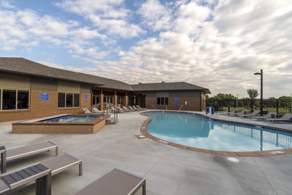 luxury resort style swimming pool with sun tanning lounge chairs at 360 at Jordan West