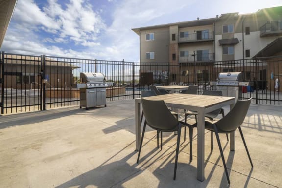 Poolside grills and picnic tables making for a perfect summer evening at 360 at Jordan West