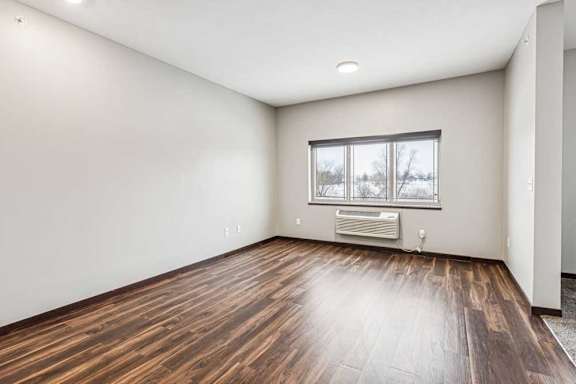 A living area with a large, three-panel window.