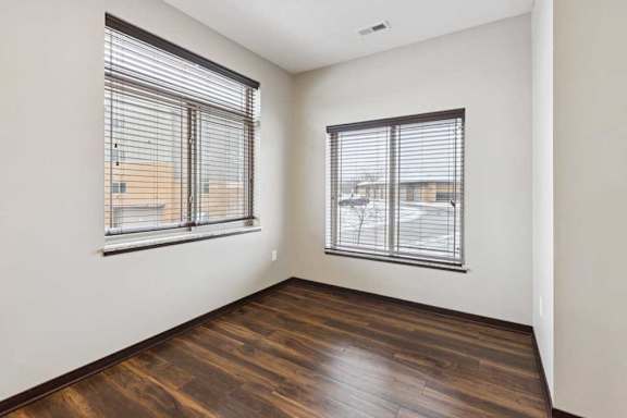 A dining area with two oversized windows.