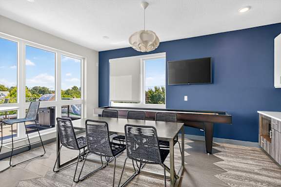 A room with blue walls and a table with chairs.