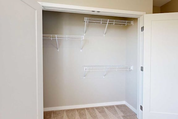 A double-door closet with built-in wire shelving.