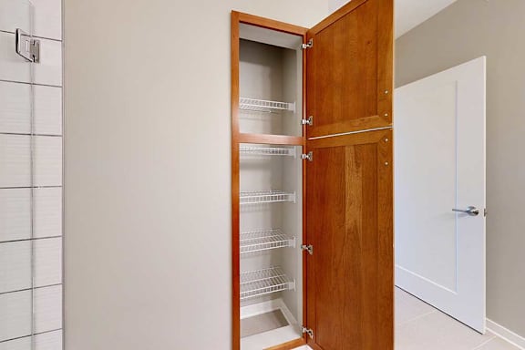 An attached bathroom with a linen closet.