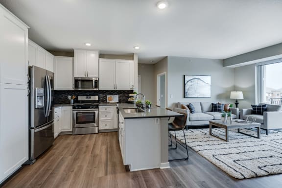 Spacious kitchen with quartz counter tops and spacious living area of 2 bedroom apartment for rent at Ascend at Woodbury best new apartments Woodbury MN 55129