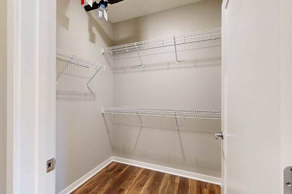 An oversized walk-in closet with built-in wire shelves.